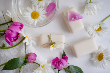 Soap cosmetic flower chamomile, peony on a light background