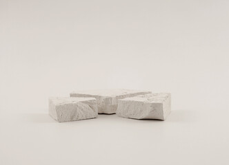 Empty stack of stones platform podium on light beige background. Minimal empty display product presentation scene.