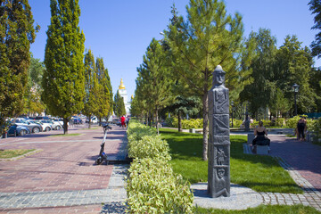 Park with sculpture of Zbruch's idol - pagan pillar-statue in Kyiv, Ukraine