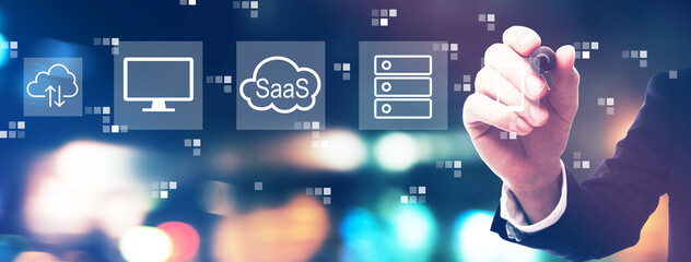 SaaS - software as a service concept with businessman on night city background