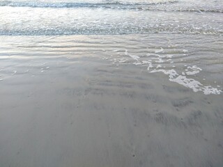 Morning Beach Ocean Receding Wave and Foam