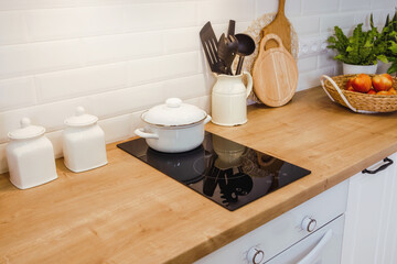 Plakat kitchen mockup with induction hob and wooden surface, copy paste