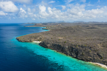 Fototapeta na wymiar Aerial view of the coast of Curaçao in the Caribbean with beach, cliff, and turquoise ocean