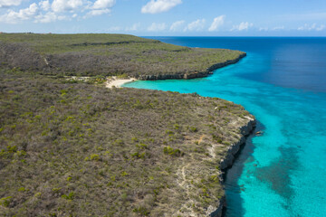 Aerial view of the coast of Curaçao in the Caribbean with beach, cliff, and turquoise ocean
