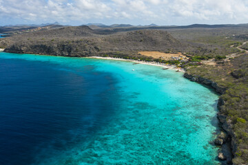 Fototapeta na wymiar Aerial view of the coast of Curaçao in the Caribbean with beach, cliff, and turquoise ocean