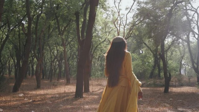 Alone Woman walking in forest, feeling lost and lonely, cinematic shot of beautiful girl walking slowly outdoor concept