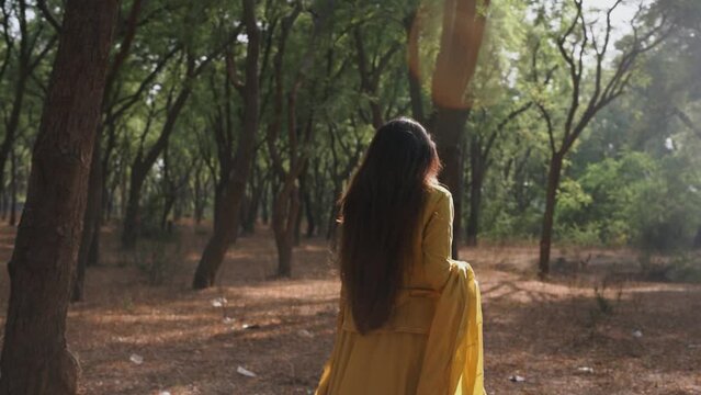 alone Woman walking in forest, feeling lost and lonely, cinematic shot of girl walking slowly in park concept