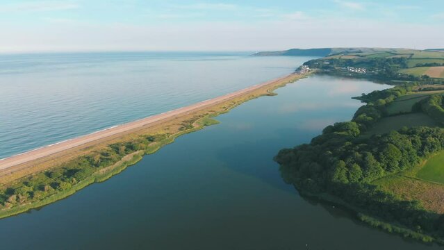 Cars driving on scenic road through the ocean - aerial drone shot