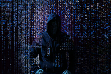Silhouette of anonymous hacker and digital binary code on dark background. Cyber attack concept