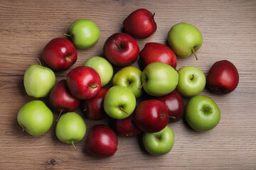 Fresh ripe red and green apples on wooden table, flat lay