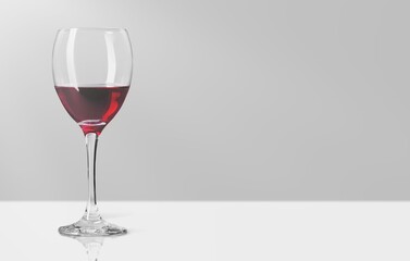 Red wine in a glass on light background