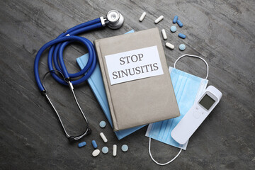 Notebook with phrase STOP SINUSITIS, stethoscope, non-contact thermometer, medical mask and...