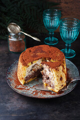 Traditional Italian Panettone cake stuffed with ricotta pudding, glanced fruits and raisins served...