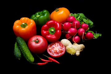 colorful healthy vegetables lie on a black background