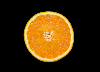 the sliced orange is lying on a black background