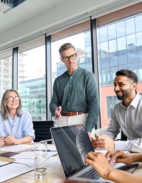 Male Caucasian Executive Ceo Businessman Leader With Diverse Partners Team, Managers Group At Meeting. Multicultural Professional Businesspeople Working Together On Business Sales Plan In Boardroom.