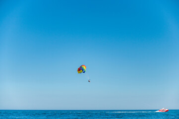 Fototapeta na wymiar Rainbow paragliding in the sea