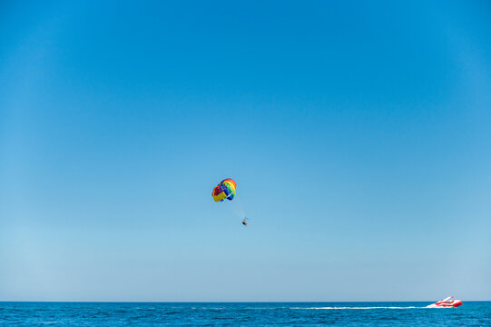 Rainbow paragliding in the sea