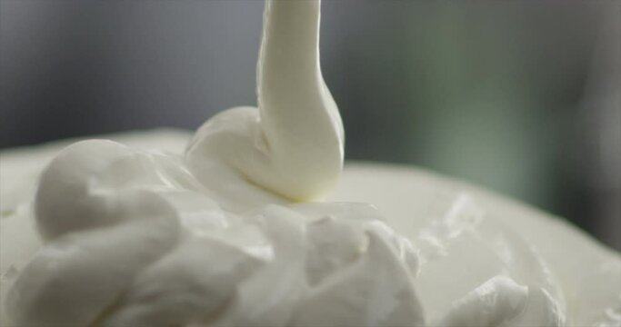 Cream mayonnaise falls on a mountain of cream