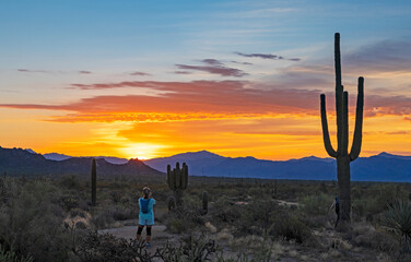 Hiker On A Desert Trail In Arizona Filming Sunrise