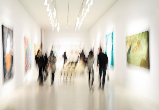 Abstract image of people in the lobby of modern art center with a blurred background