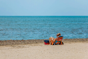 Fototapeta na wymiar Man Reading at the Beach