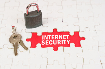 On puzzles there is a lock and keys, on a red surface there is an inscription - Internet security