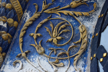 A fragment of a beautiful bas-relief with a floral ornament on the arch above the entrance. Side...