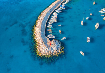 Aerial view of boats and yachts in dock, breakwater and blue sea - obrazy, fototapety, plakaty