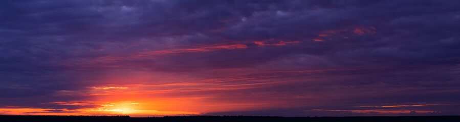 Clouds and orange sunset. Worsening weather conditions. Emergency. Abstract natural background.