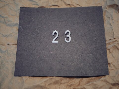 23 Numbers on Gray with Brown Background