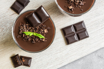 Chocolate cocoa pudding, mousse in glass cup on rustic table, supangle