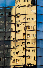 Reflections of yellow building in another building