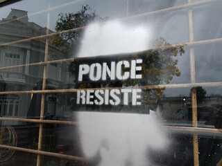 Ponce resist sign spray painted on window in Ponce Puerto Rico