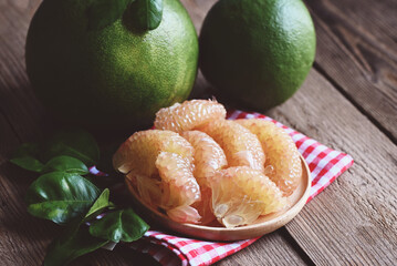 fresh green pomelo peeled and leaf frome pomelo tree , pummelo , grapefruit in summer tropical...