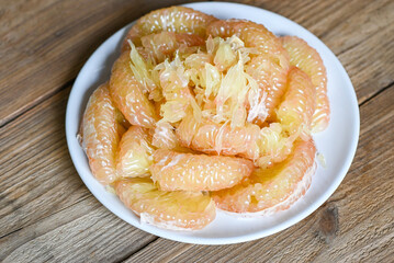 Pomelo fruit on white plate, fresh pomelo peeled frome pomelo tree , pummelo , grapefruit in summer...