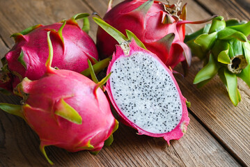 dragon fruit cut half on wooden with pitahaya background , fresh dragon fruit tropical in the asian...