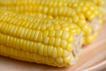 sweet corn cooked on wooden plate background, close up ripe corn cobs steamed or boiled sweetcorn for food vegan dinner or snack