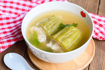 Stuffed bitter gourd with seasoned minced pork soup , Menu healthy food clear soup bowl with bitter gourd or bitter melon soup