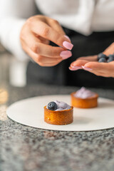 young girl chef makes desserts. bakes sweets and cakes. makes blanks and prepares fruits for the filling. baking, dessert, sweets, complex cooking processes.