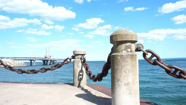 Lake Ontario Waterfront Trail view of Burlington Brant Street Pier under blue sky and white clouds in summer