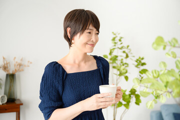 Woman relaxing with a cup of coffee, etc.