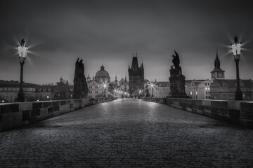 Black and white Charles bridge on Vltava river at night - Prague, Czech Republic