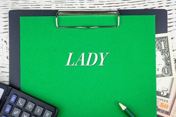 LADY - word (text) dollar bills on green background, pencil, calculator and wooden white table. Business concept: buying, selling, commerce (copy space).