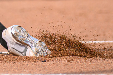 softball player foot safe in the dirt of the ballfields