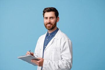 Naklejka na ściany i meble Professional man doctor In white uniform holding medical chart over blue background