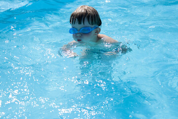 outdoor swimming pool boy with swimming glasses