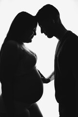 Pregnant silhouette with husband on white background, studio, close up