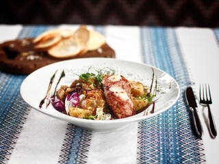 Meat with vegetables on the white plate