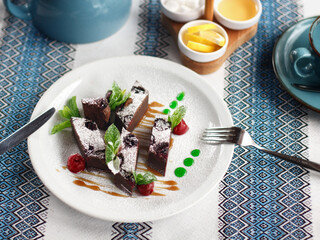 Chocolate dessert with mint on the white plate